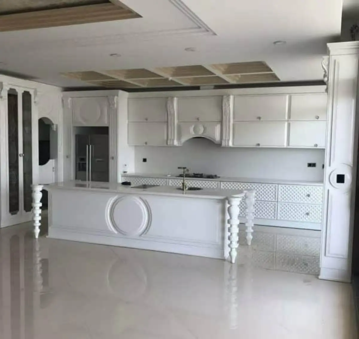 کابینت و جزیره سفید انزو با ستونهای کندهکاریشده در زیر جزیره